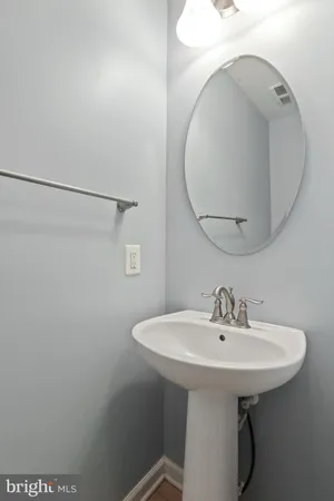 a bathroom with a sink a mirror and shower
