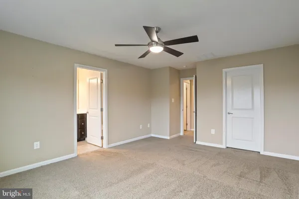 a view of an empty room and closet area
