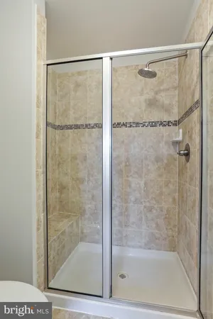 a bathroom with a glass shower door