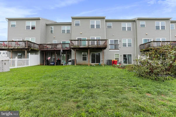 a view of an house with backyard and balcony
