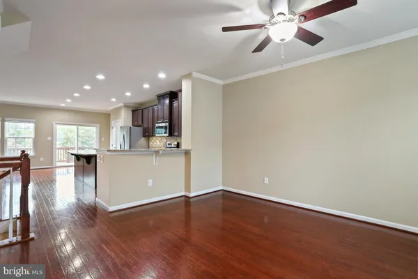 a view of a kitchen and dining room with wooden floor
