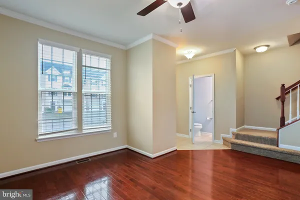 wooden floor in an empty room with a window