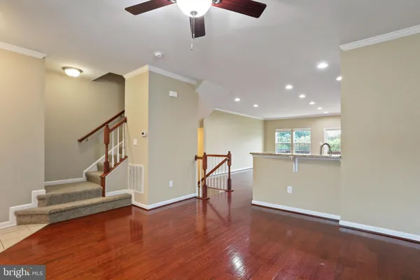 a view of entryway and hall with wooden floor