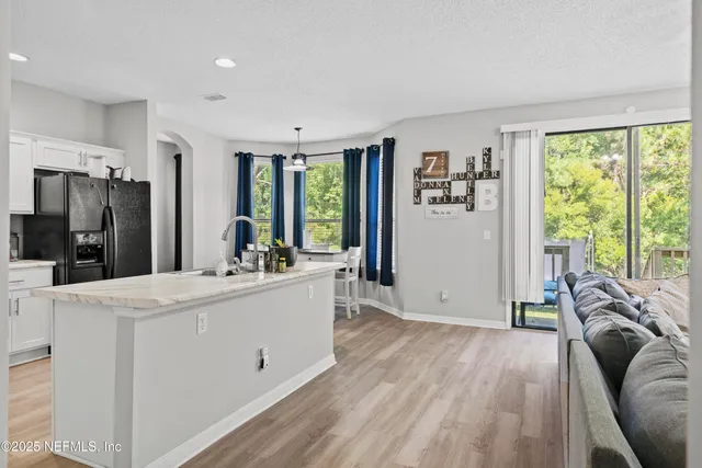 a kitchen with a refrigerator and a stove top oven