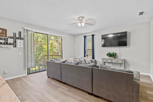 a bathroom with a granite countertop sink a mirror and a shower