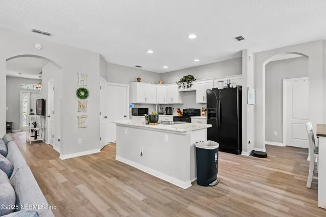 a white bath tub sitting in a bathroom next to a window