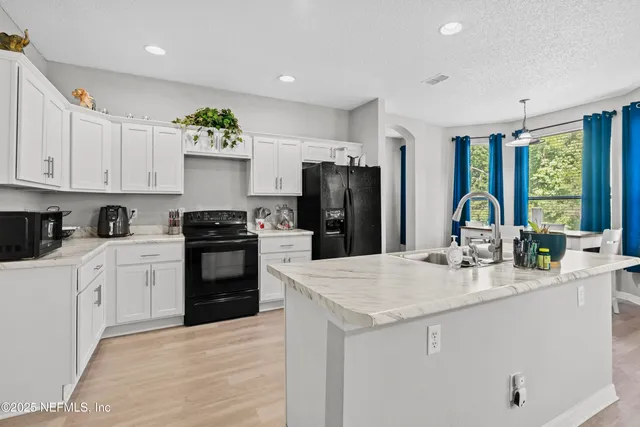 a bathroom with a sink a toilet a mirror and shower