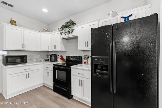 a building outdoor space with patio furniture and potted plants