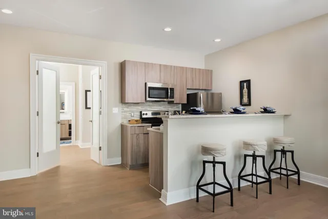 a view of a dining room with furniture and a kitchen