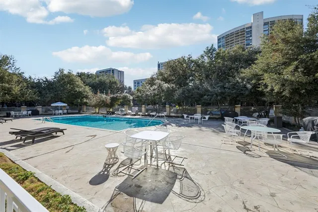 a swimming pool with outdoor seating and yard