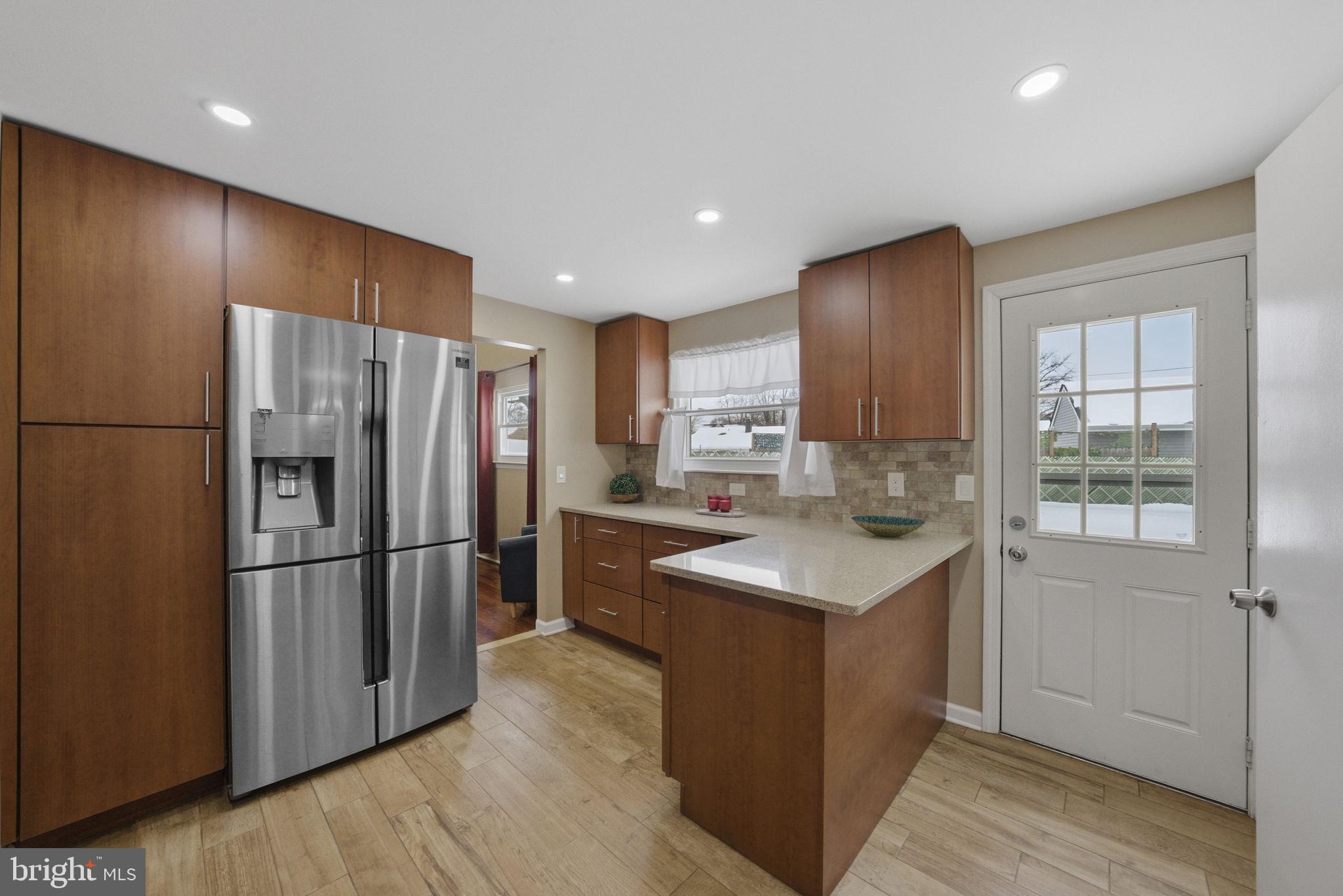 10 Magee Road Edison, NJ 08817 - Photo 11 of 45 a kitchen with a refrigerator a sink and cabinets