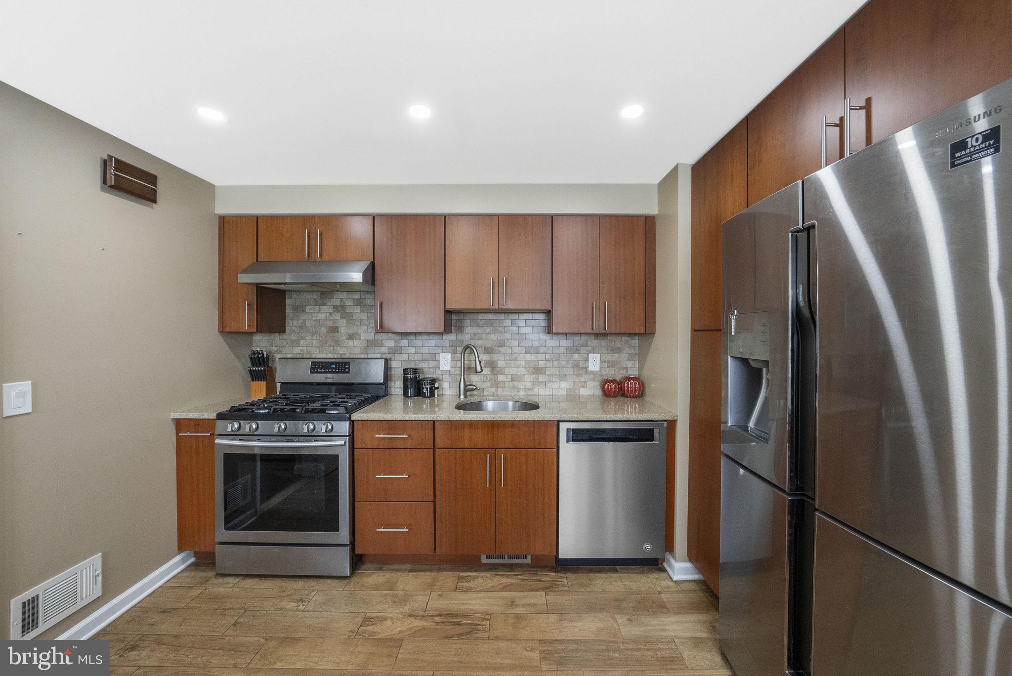 10 Magee Road Edison, NJ 08817 - Photo 13 of 45 a kitchen with stainless steel appliances granite countertop a refrigerator a stove and a sink