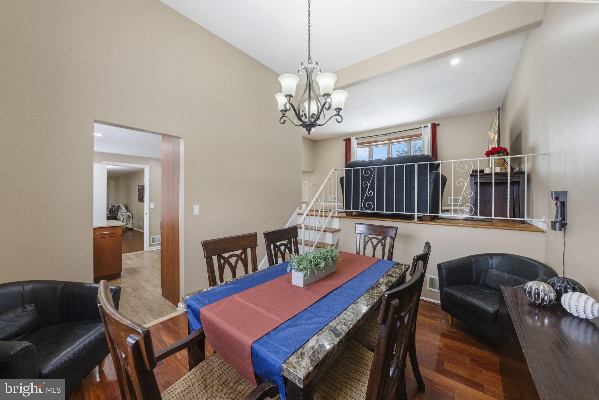 10 Magee Road Edison, NJ 08817 - Photo 14 of 45 a living room with furniture a dining table and a chandelier
