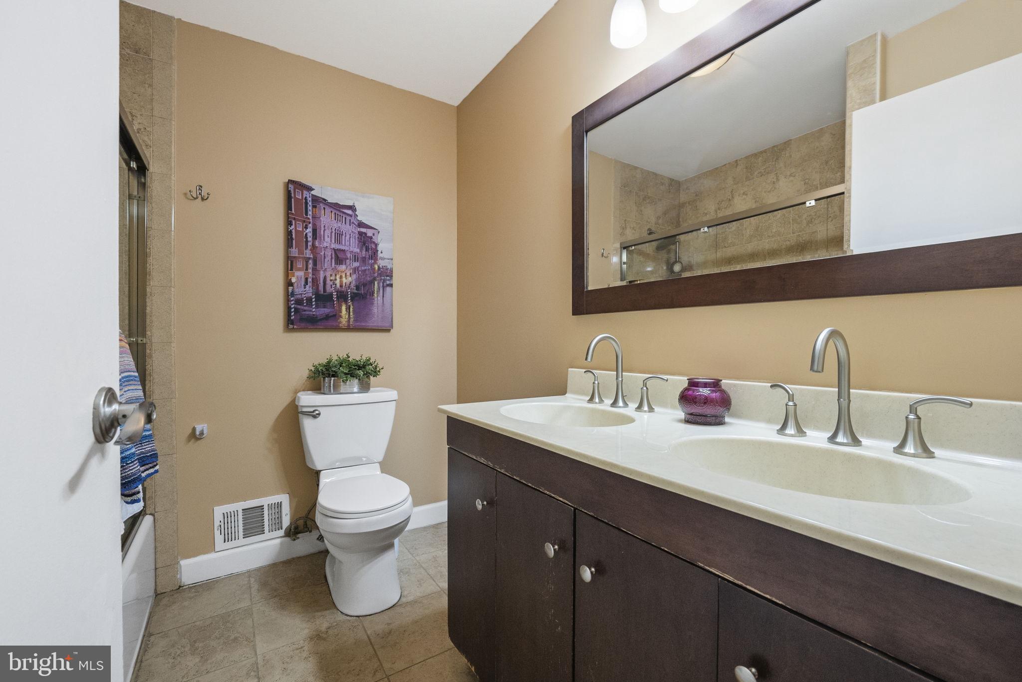 10 Magee Road Edison, NJ 08817 - Photo 35 of 45 a bathroom with a toilet sink and mirror