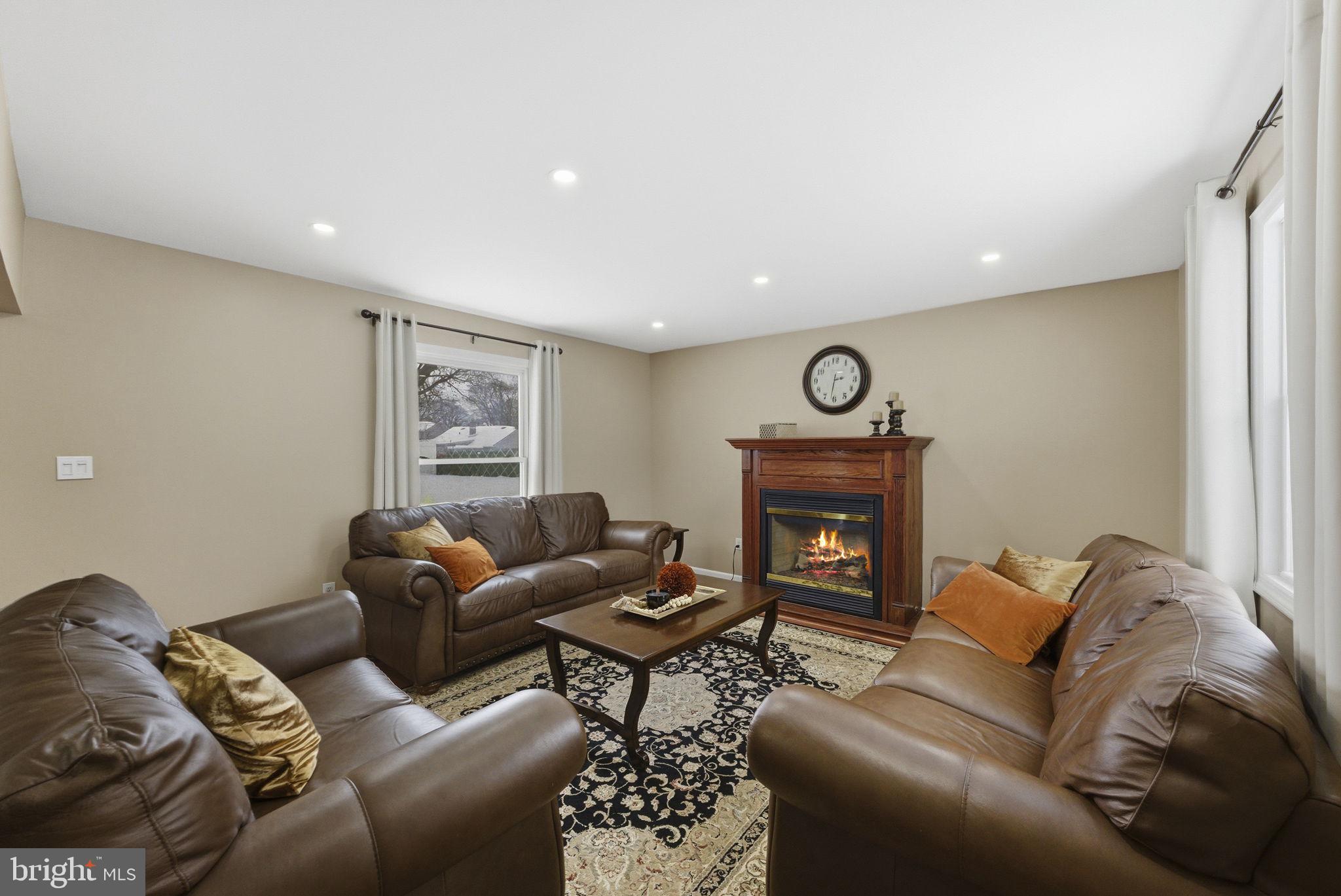 10 Magee Road Edison, NJ 08817 - Photo 6 of 45 a living room with furniture and fireplace