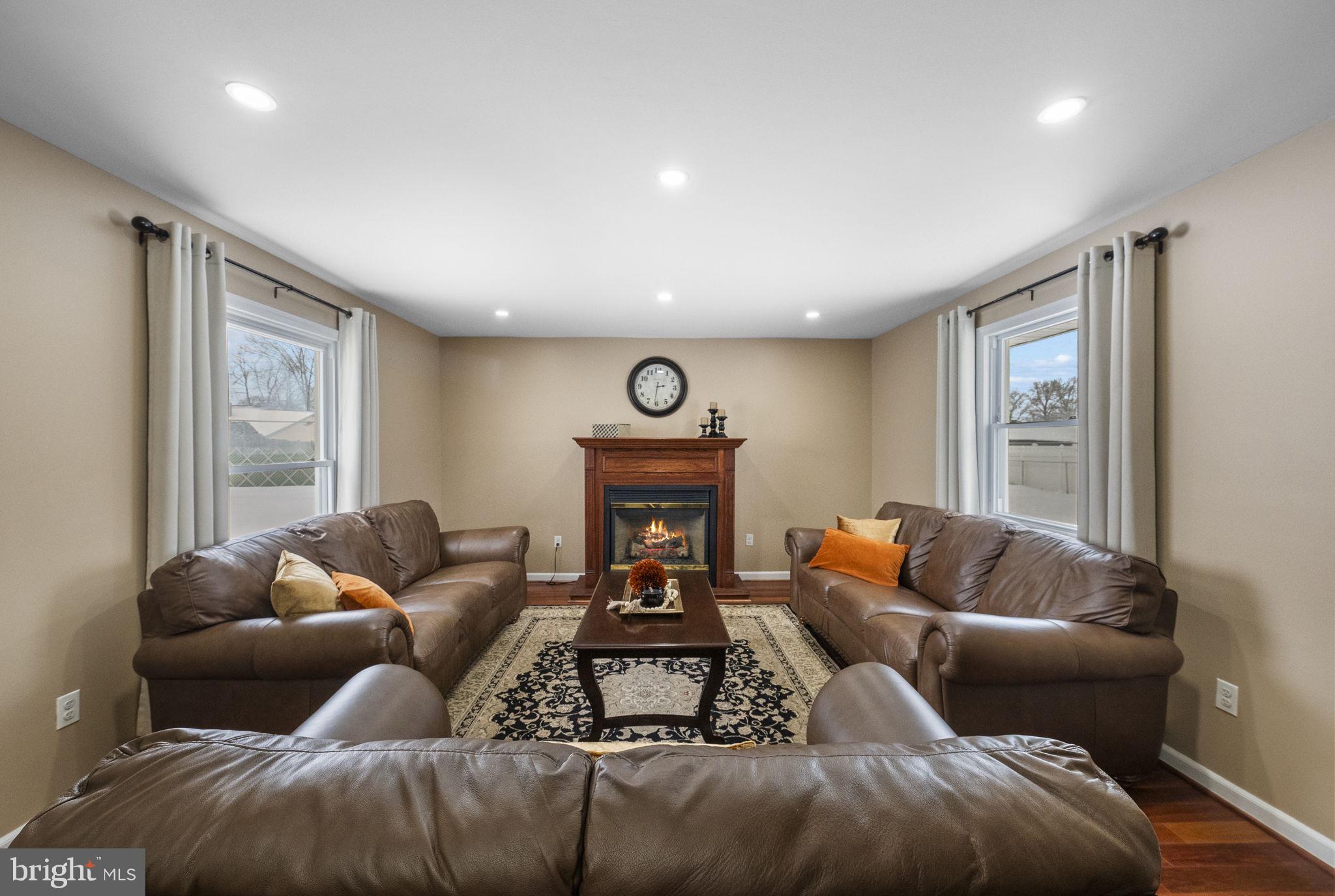 10 Magee Road Edison, NJ 08817 - Photo 7 of 45 a living room with furniture and a fireplace