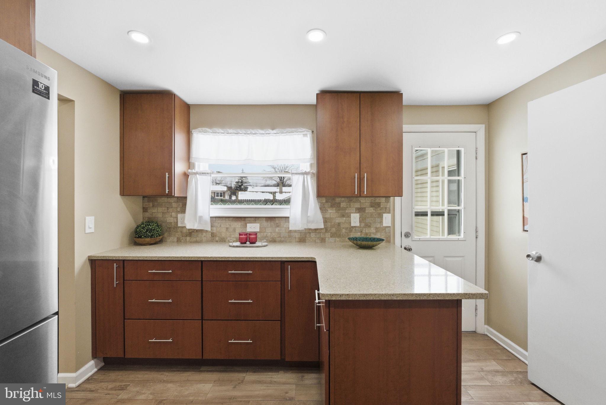 10 Magee Road Edison, NJ 08817 - Photo 10 of 45 a kitchen with a sink a refrigerator and cabinets