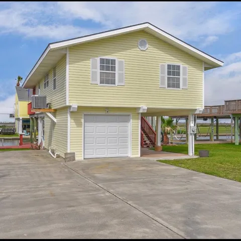 a view of a house with a yard and garage