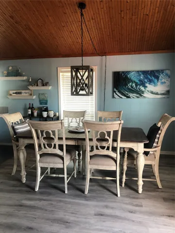 a dining room with furniture and wooden floor
