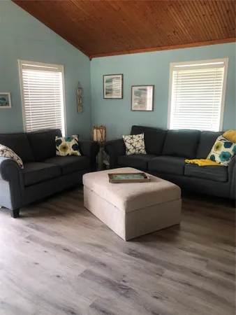 a living room with furniture window and wooden floor