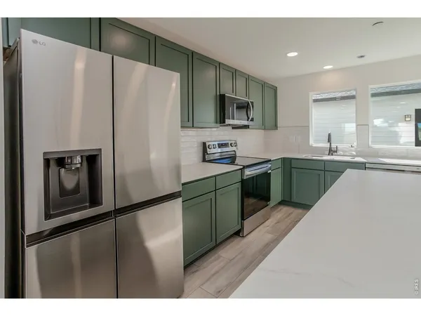 a kitchen with a sink and cabinets