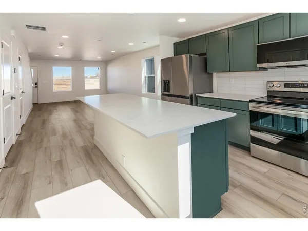 a kitchen with a sink cabinets and a wooden floor