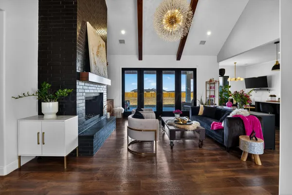 a living room with fireplace furniture and a wooden floor