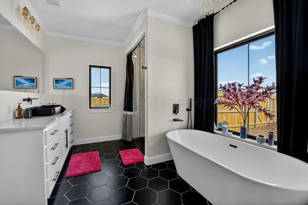 a bathroom with a bathtub and a double vanity sink