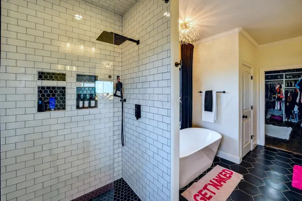 a spacious en suite bathroom with a double vanity sink and a mirror