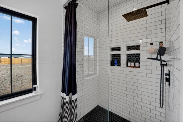 a bedroom with a bed closet and a large window