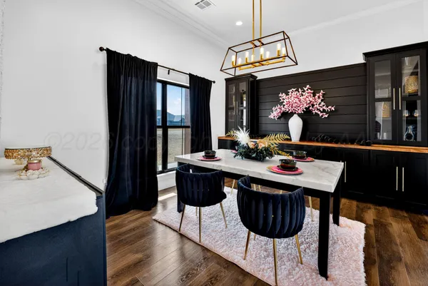 a view of a dining room with furniture and chandelier