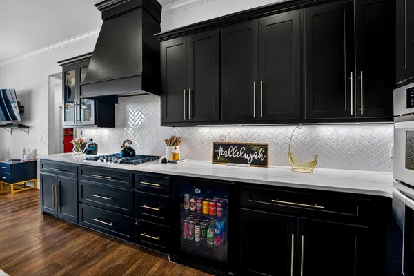 a kitchen with granite countertop a stove and cabinets