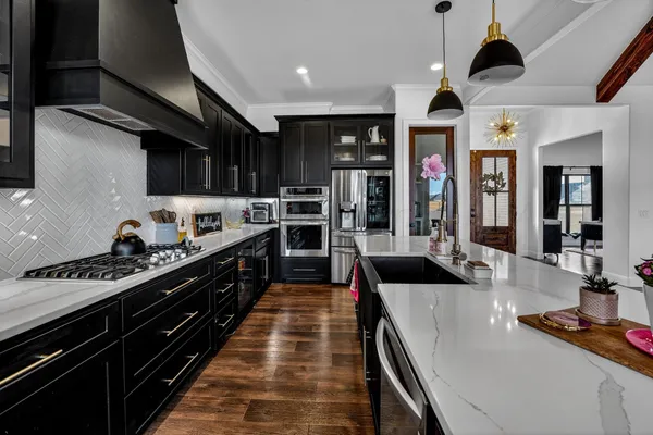 a kitchen with stainless steel appliances granite countertop a stove and a refrigerator