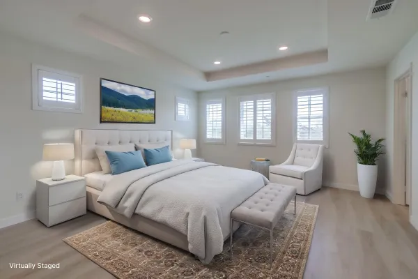 a spacious bedroom with a bed and glass windows