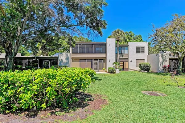 an aerial view of a house with a yard and lake view
