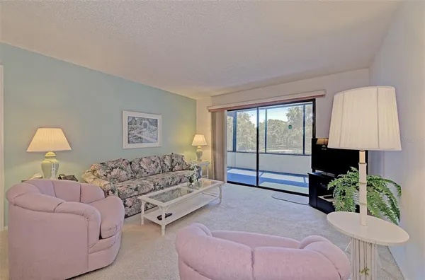 a living room with furniture and a lamp