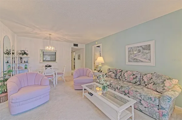 a dining room with furniture and chandelier