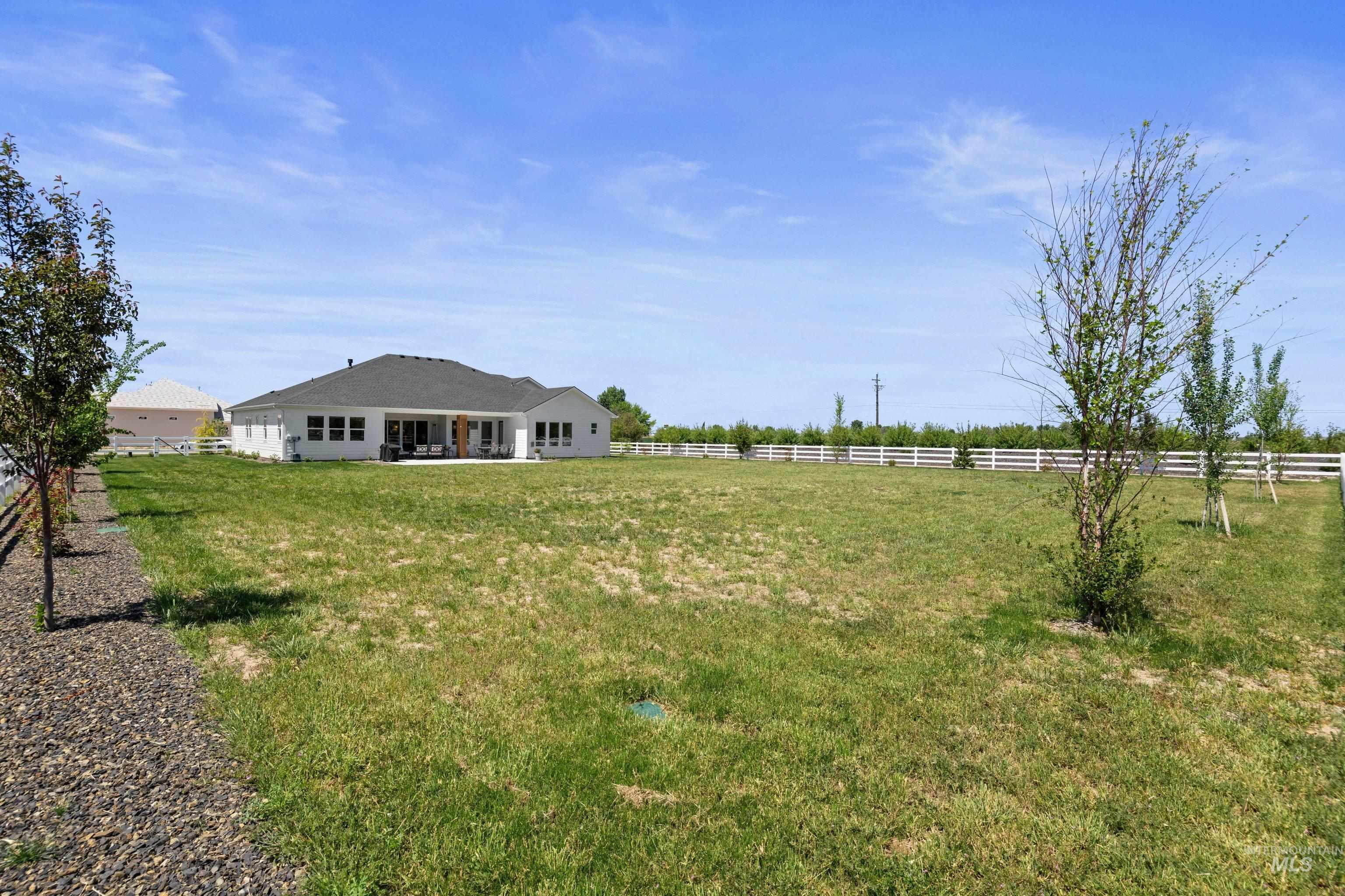 24990 Belgian Way Middleton, ID 83644 - Photo 41 of 50 Expansive lawn area with a white perimeter fence