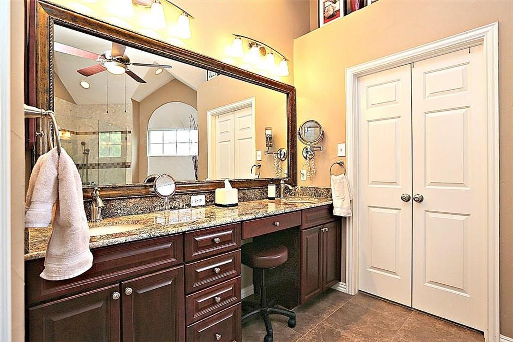 14588 Poe Court Addison, TX 75001 - Photo 17 of 28 a bathroom with a granite countertop sink a vanity and a mirror