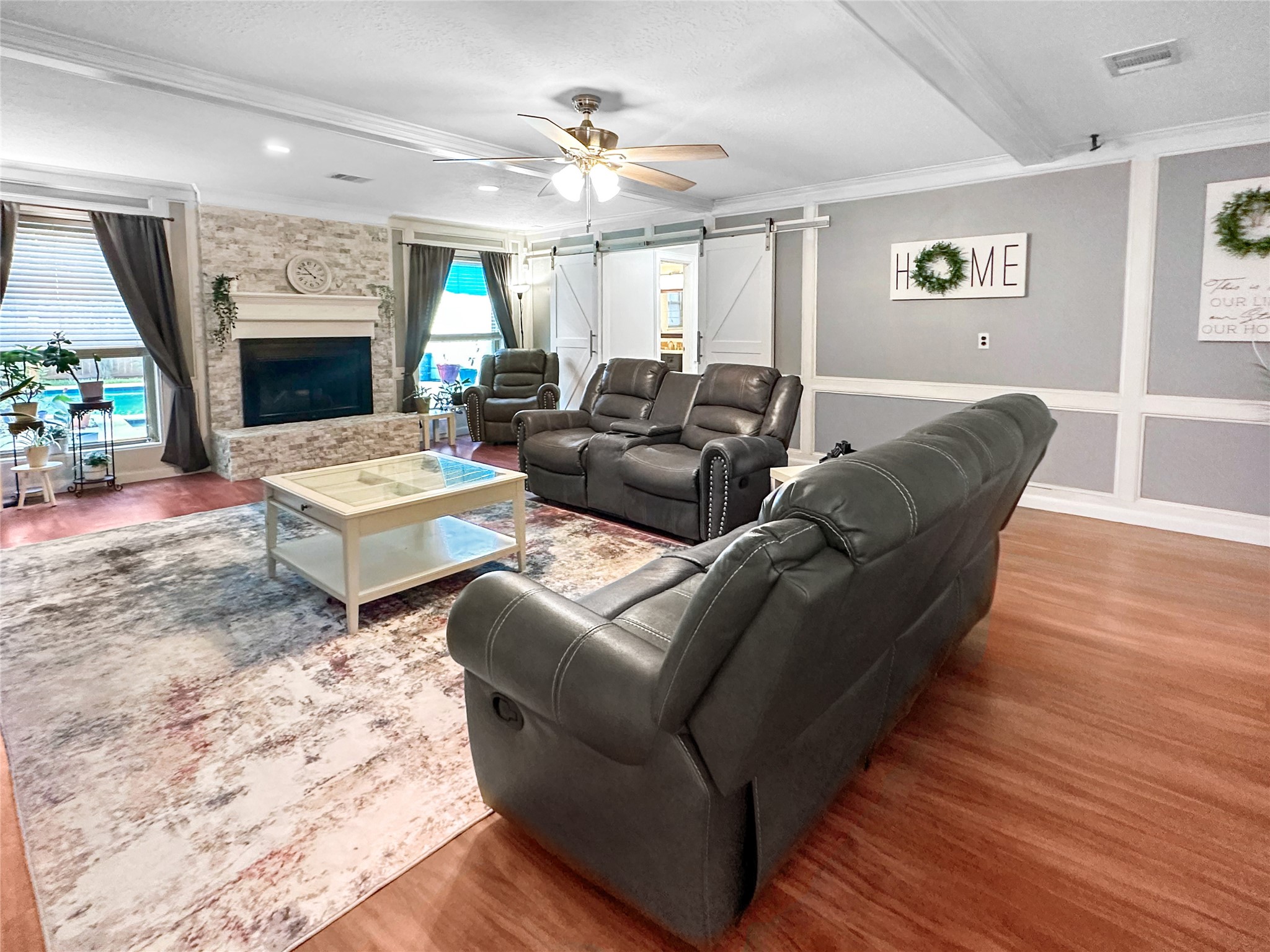 6511 Castle Pine Lane Spring, TX 77379 - Photo 21 of 49 Beautiful main living area centered around a cozy fireplace with expansive windows, rich flooring, and an airy layout designed for comfortable everyday living
