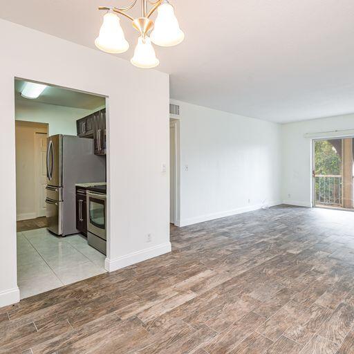 250 Northeast 20th Street, Unit 3210 Boca Raton, FL 33431 - Photo 11 of 26 a view of a kitchen with a sink and a refrigerator