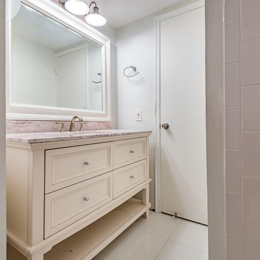 250 Northeast 20th Street, Unit 3210 Boca Raton, FL 33431 - Photo 19 of 26 a bathroom with a double vanity sink and mirror