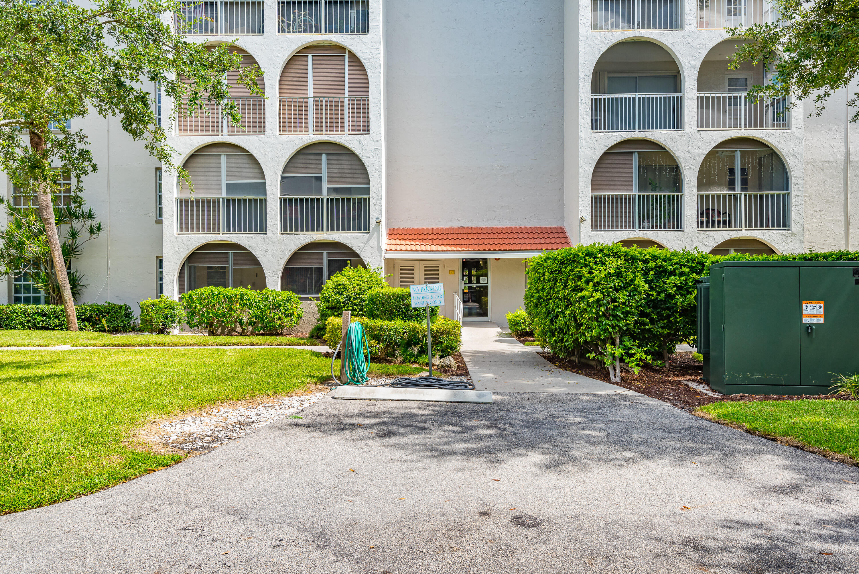 250 Northeast 20th Street, Unit 3210 Boca Raton, FL 33431 - Photo 2 of 26 a front view of a house with garden