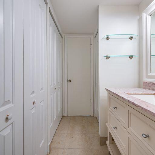 250 Northeast 20th Street, Unit 3210 Boca Raton, FL 33431 - Photo 21 of 26 a bathroom with a granite countertop sink and a mirror