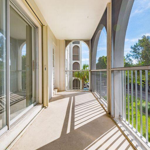 250 Northeast 20th Street, Unit 3210 Boca Raton, FL 33431 - Photo 25 of 26 a view of a balcony with wooden floor and iron fence