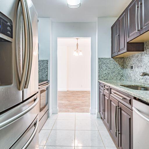 250 Northeast 20th Street, Unit 3210 Boca Raton, FL 33431 - Photo 8 of 26 a kitchen with stainless steel appliances granite countertop a refrigerator and a sink
