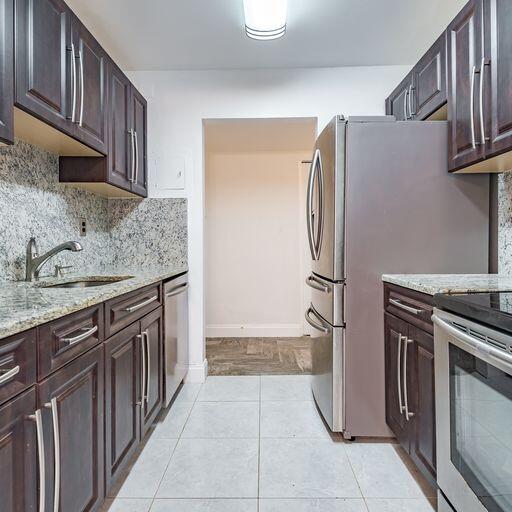 250 Northeast 20th Street, Unit 3210 Boca Raton, FL 33431 - Photo 9 of 26 a kitchen with stainless steel appliances granite countertop a refrigerator and a sink
