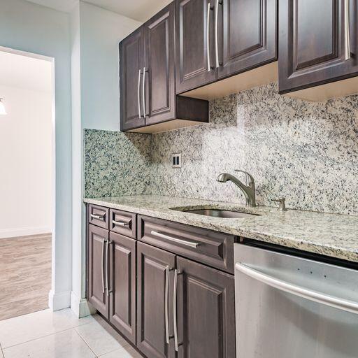 250 Northeast 20th Street, Unit 3210 Boca Raton, FL 33431 - Photo 10 of 26 a kitchen with stainless steel appliances granite countertop a sink and cabinets