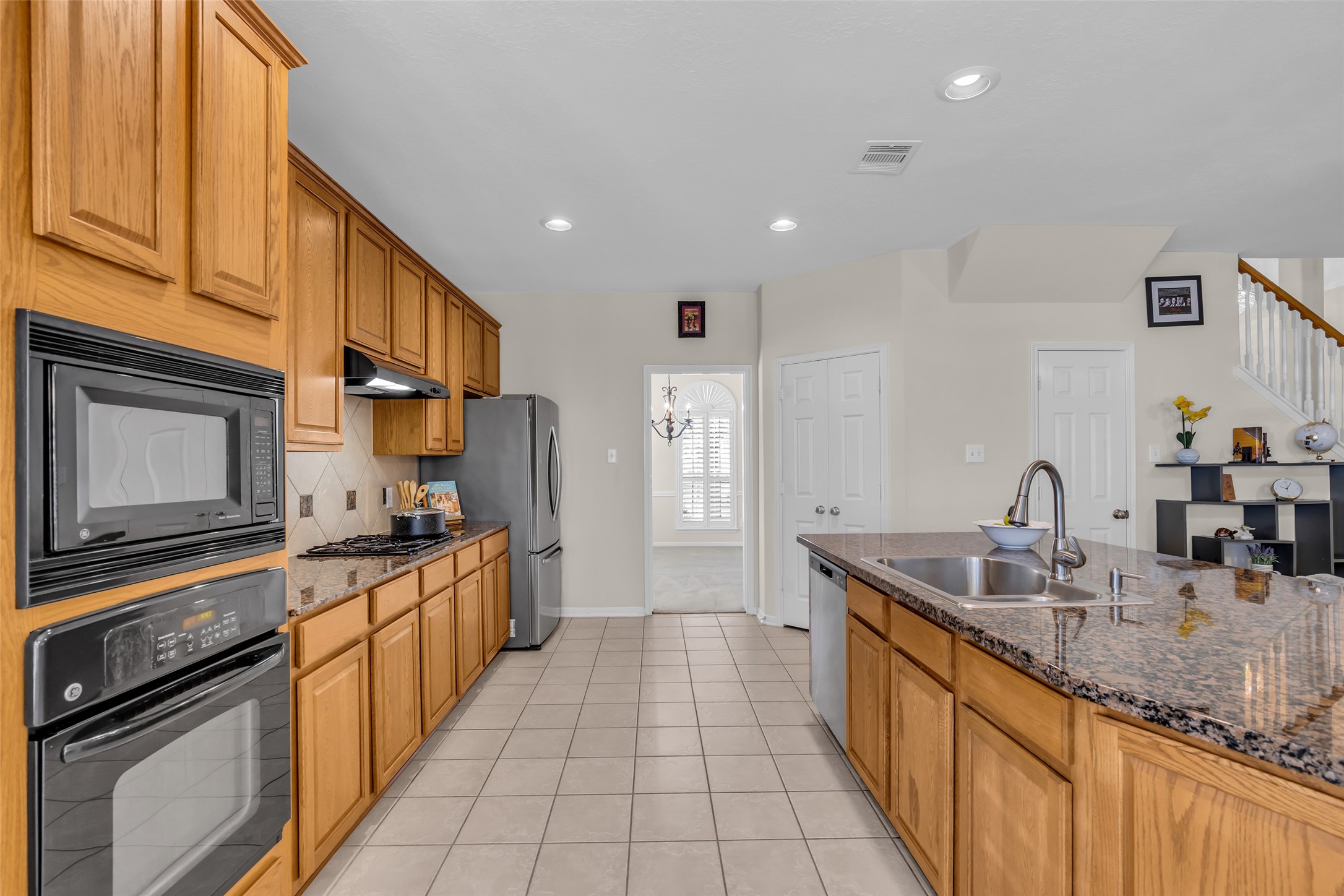 6807 Chapelfield Lane Houston, TX 77049 - Photo 16 of 42 a kitchen with granite countertop a sink stove and cabinets
