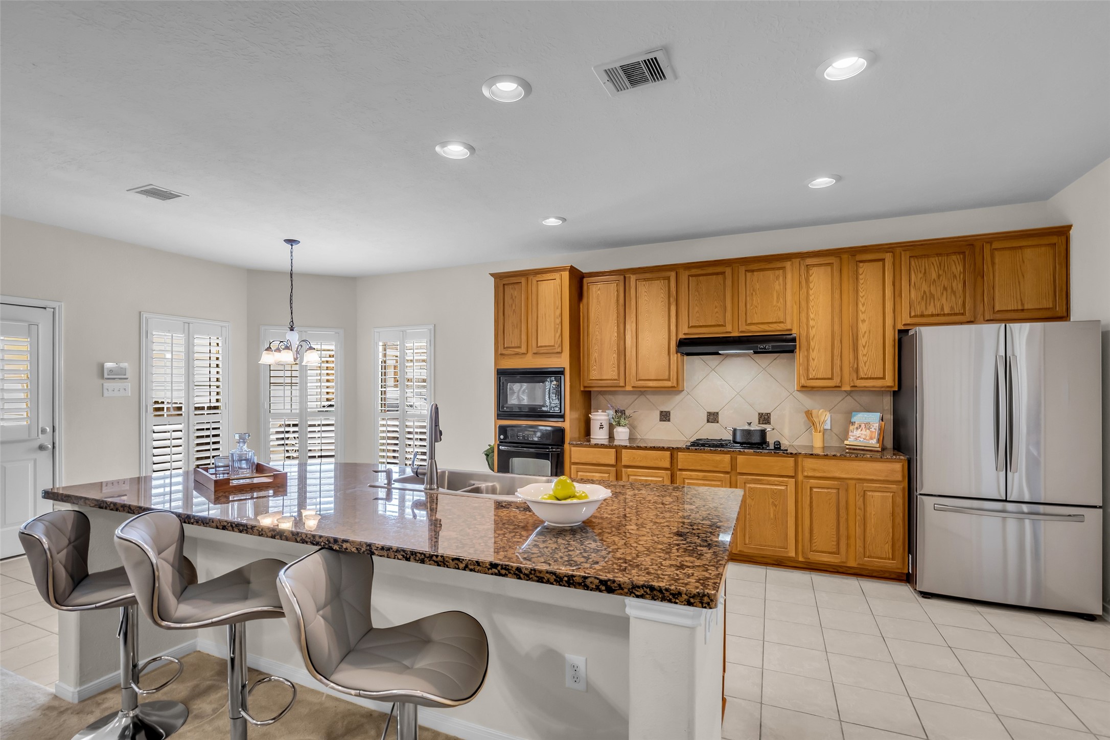 6807 Chapelfield Lane Houston, TX 77049 - Photo 19 of 42 a kitchen with granite countertop a sink stainless steel appliances and cabinets